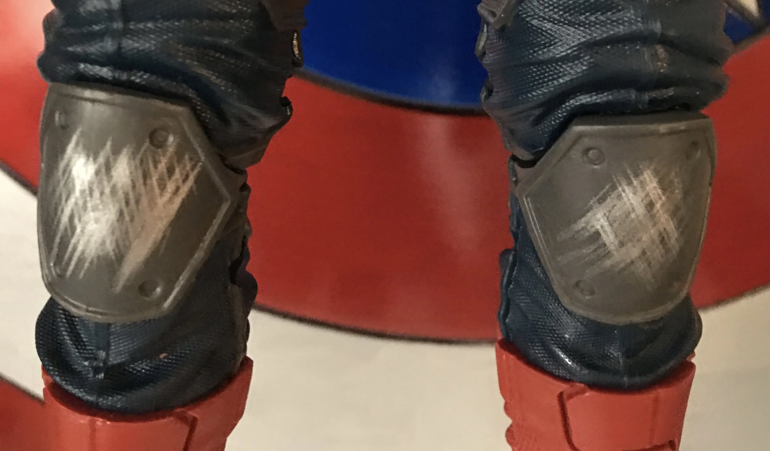 Scuffed knee pads show evidence of battle.