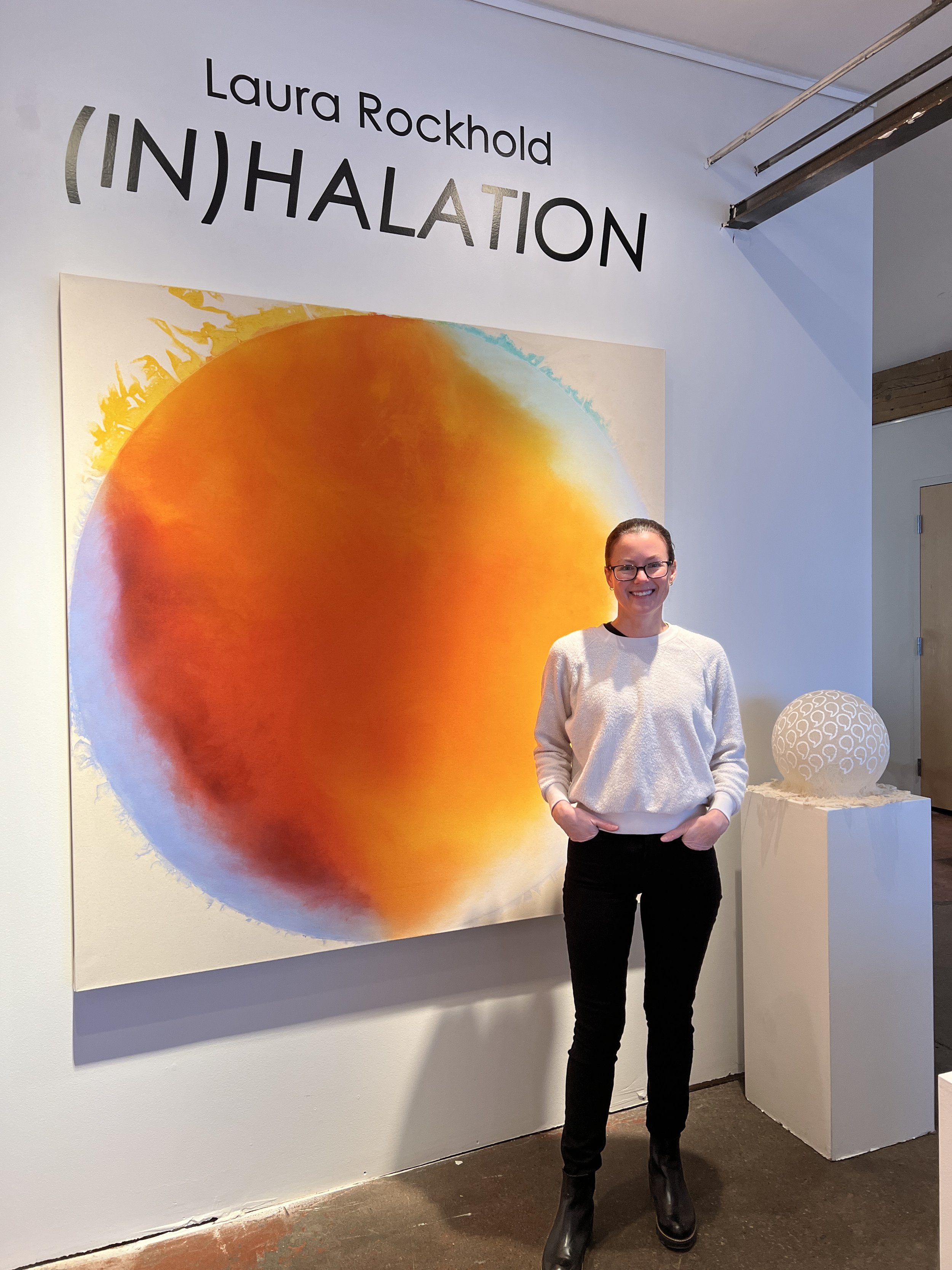(IN)HALATION Install Picture - Laura Rockhold with her RENEWAL painting