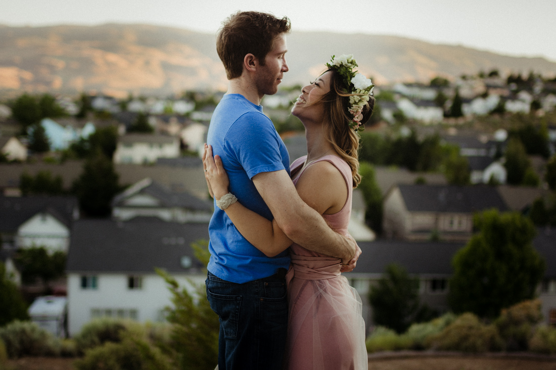 Husband and wife hugging each other on top of a hill in Reno, NV 