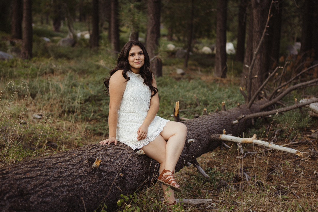 Lake Tahoe senior pictures of a girl sitting on a log 