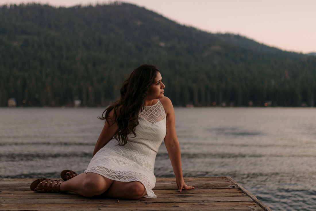 Lake Tahoe senior pictures of a girl sitting at a dock during sunset 