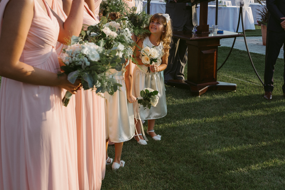 California Wedding private venue flower girl standing next to the bridesmaids