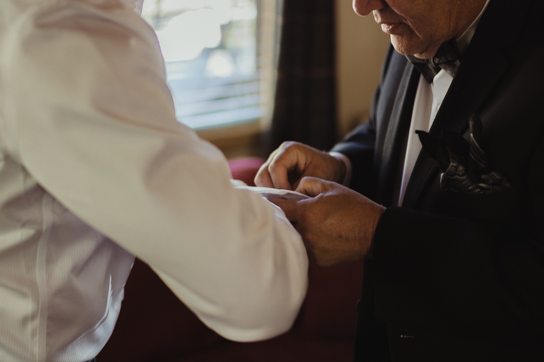 Incline Village wedding dad helping groom with his cuff photo 