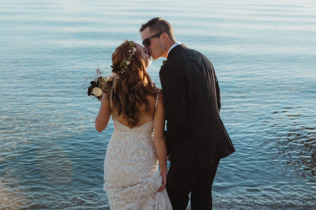 Incline village beach wedding couple kissing on the dock photo 