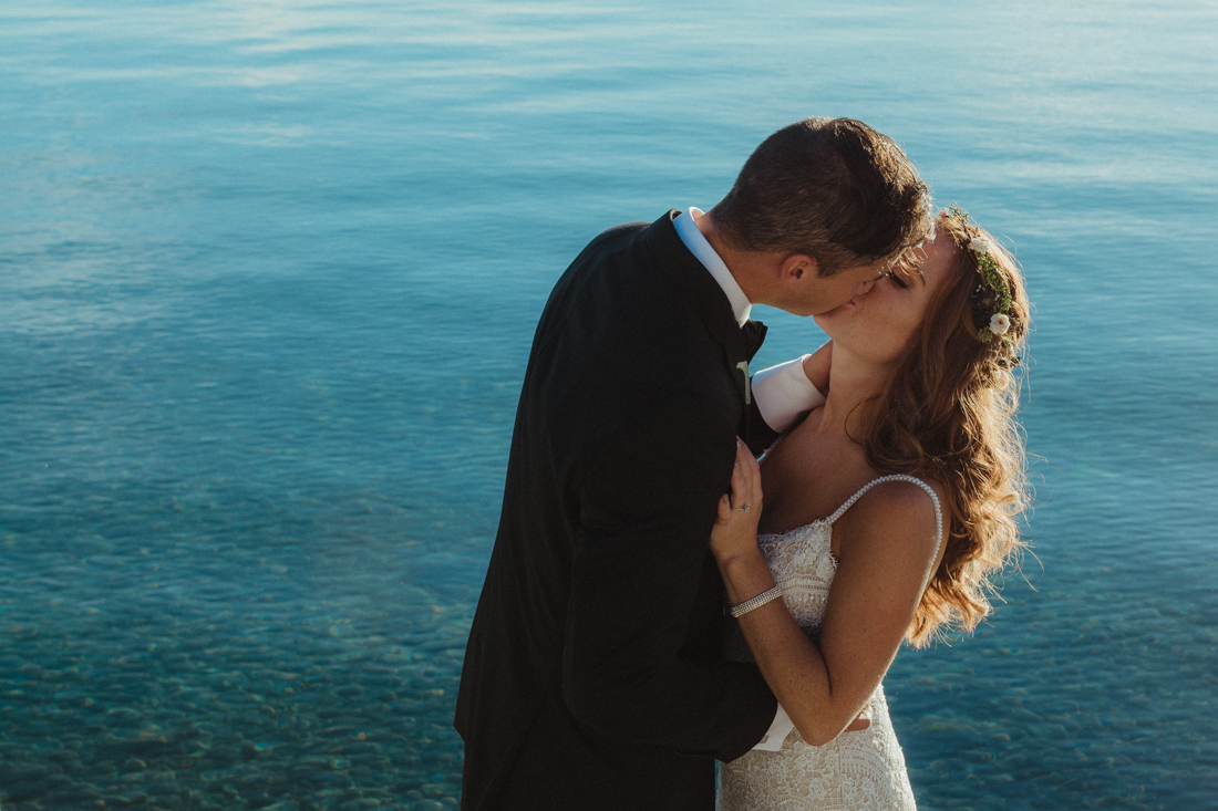 Incline village beach wedding couple standing in front of Lake Tahoe photo
