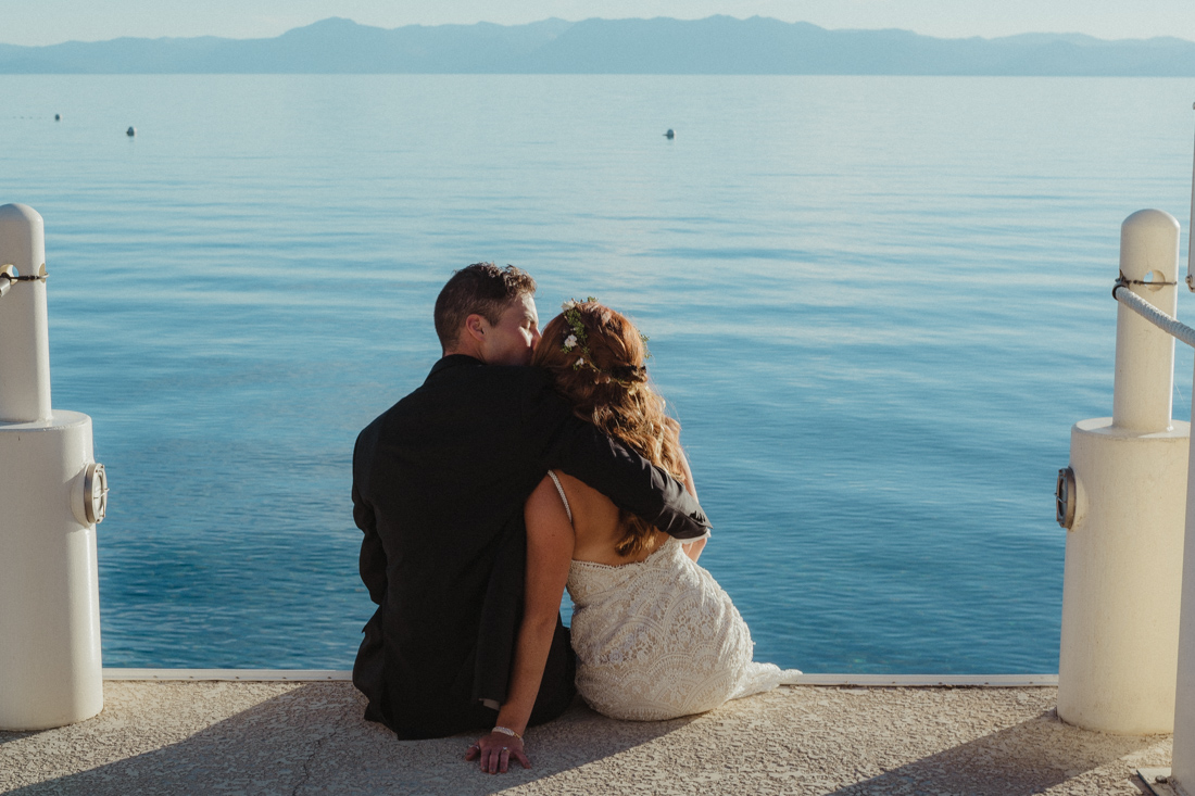 Incline village beach wedding couple sitting on the dock photo
