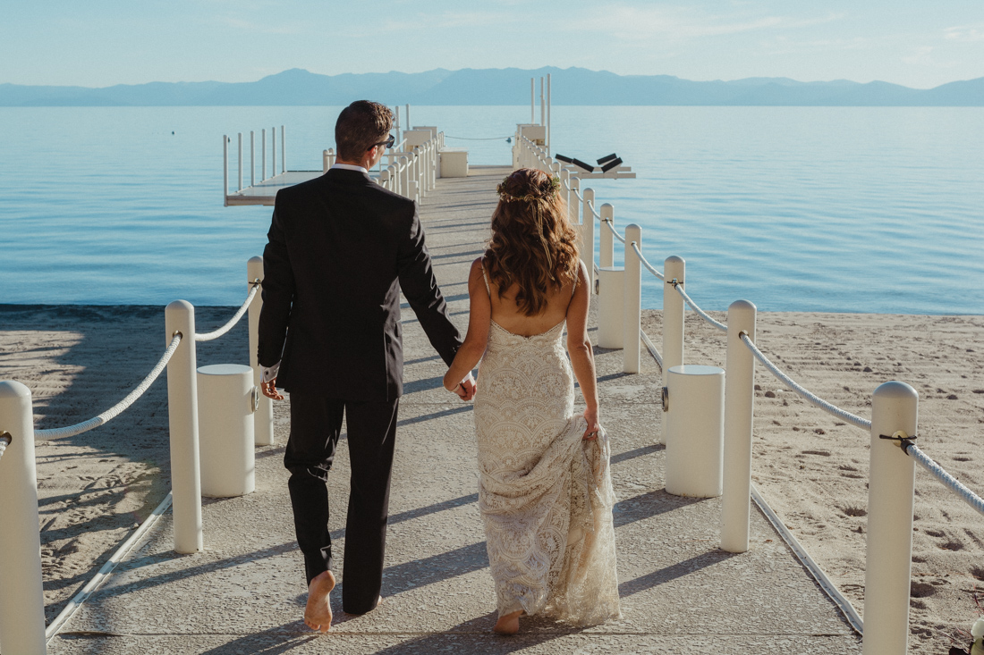 Incline village beach wedding couple walking on the dock photo
