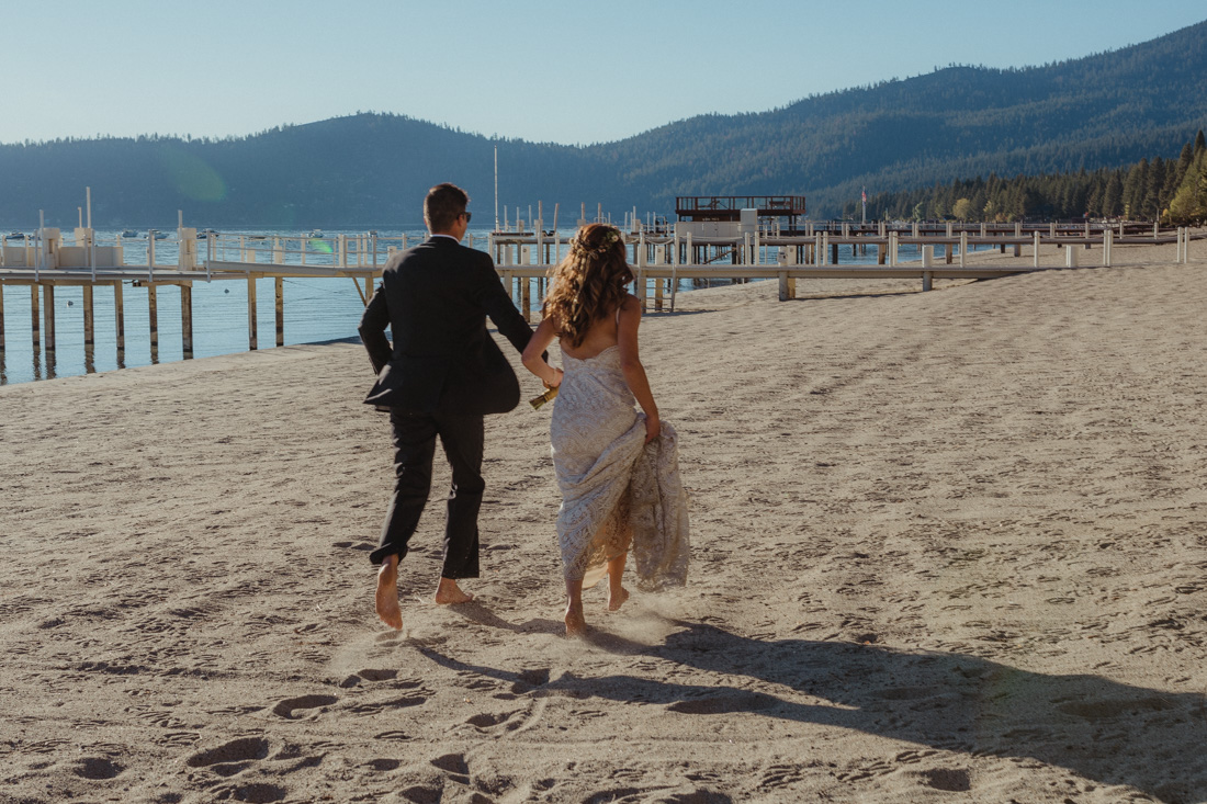 Incline village beach wedding couple running on the sand photo 
