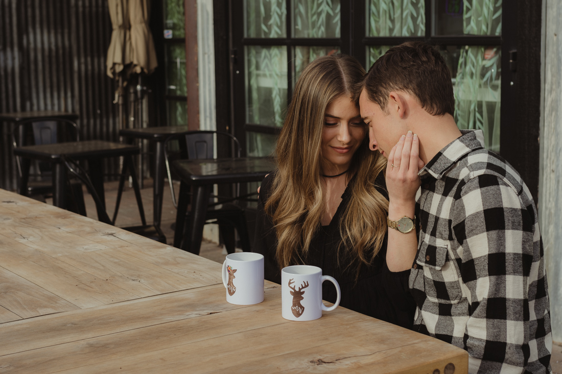 couple modeling mugs during their engagement session in Truckee CA