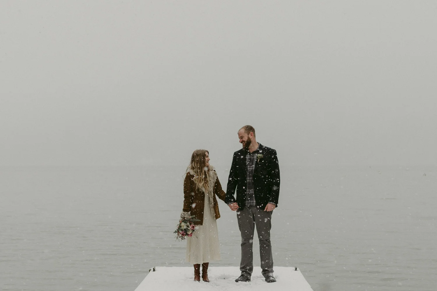 Nevada City, CA elopement photo couple holding hands at a dock in Scotts Flat Lake