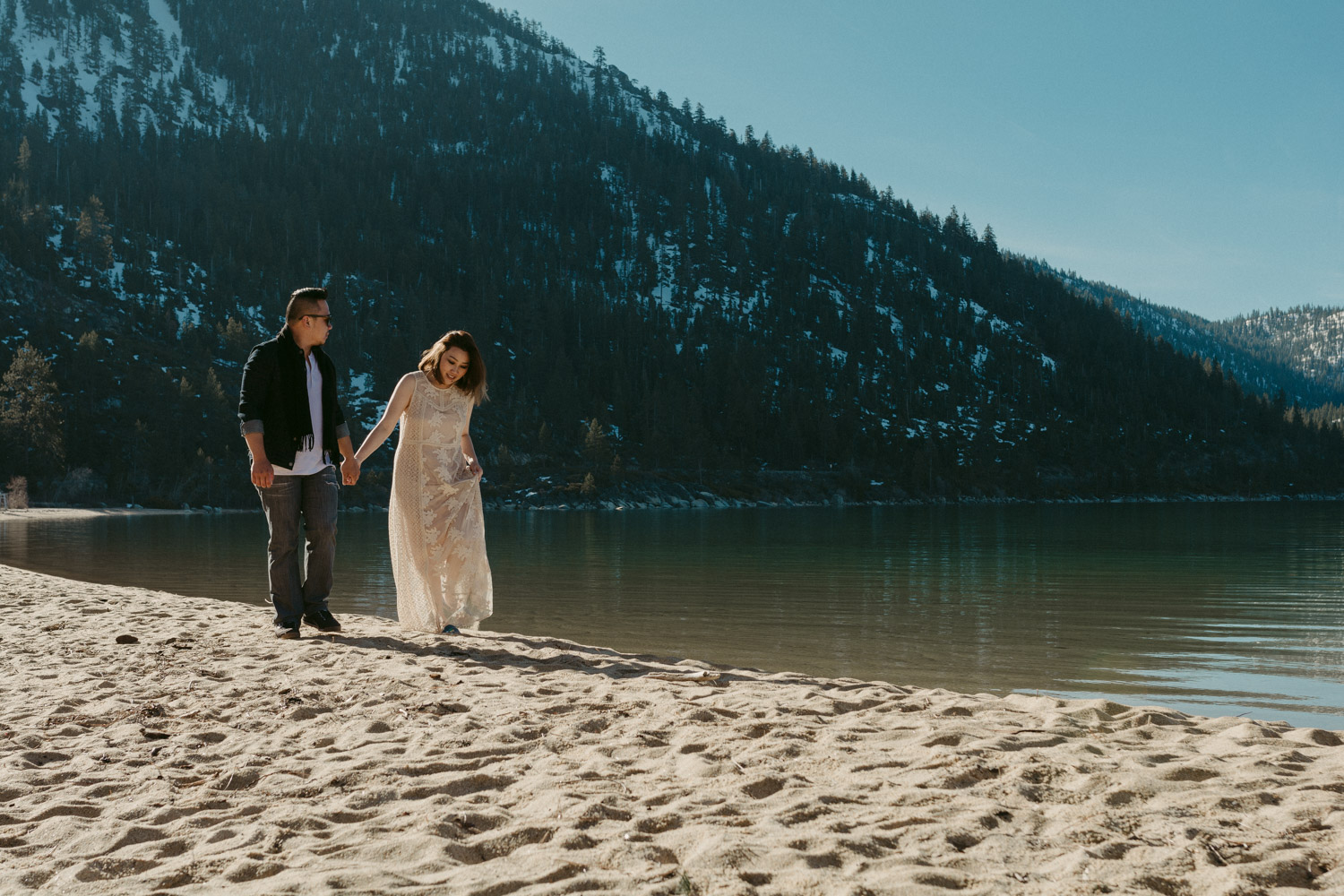 Lake Tahoe session couple walking on the beach holding hands photo