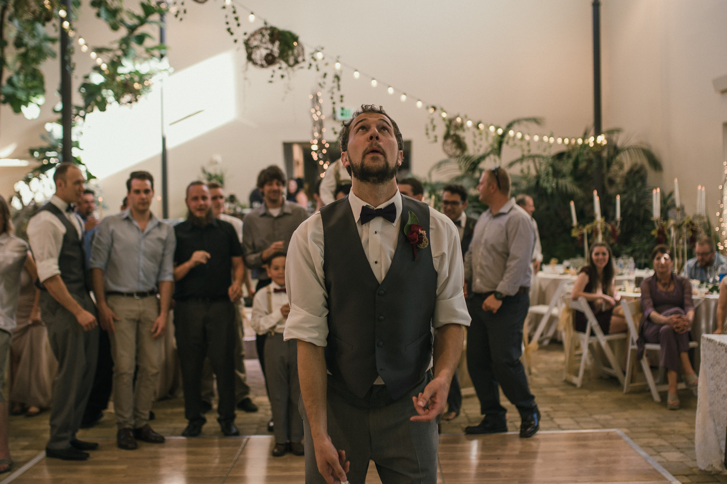 May Museum wedding, groom throwing the garter photo