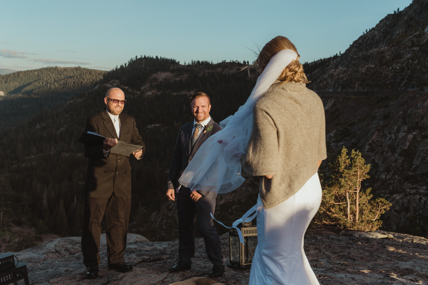 North Lake Tahoe wedding bride walking down the isle with the sun glowing behind her photo
