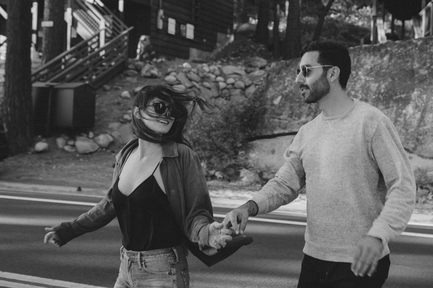 North Lake Tahoe engagement couple running on the streets of Donner photo