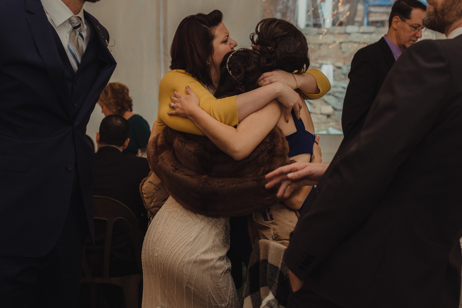 Nevada City wedding reception guests hugging photo