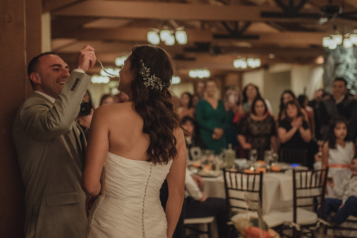 Tannenbaum Wedding Venue groom feeding the cake to his bride photo