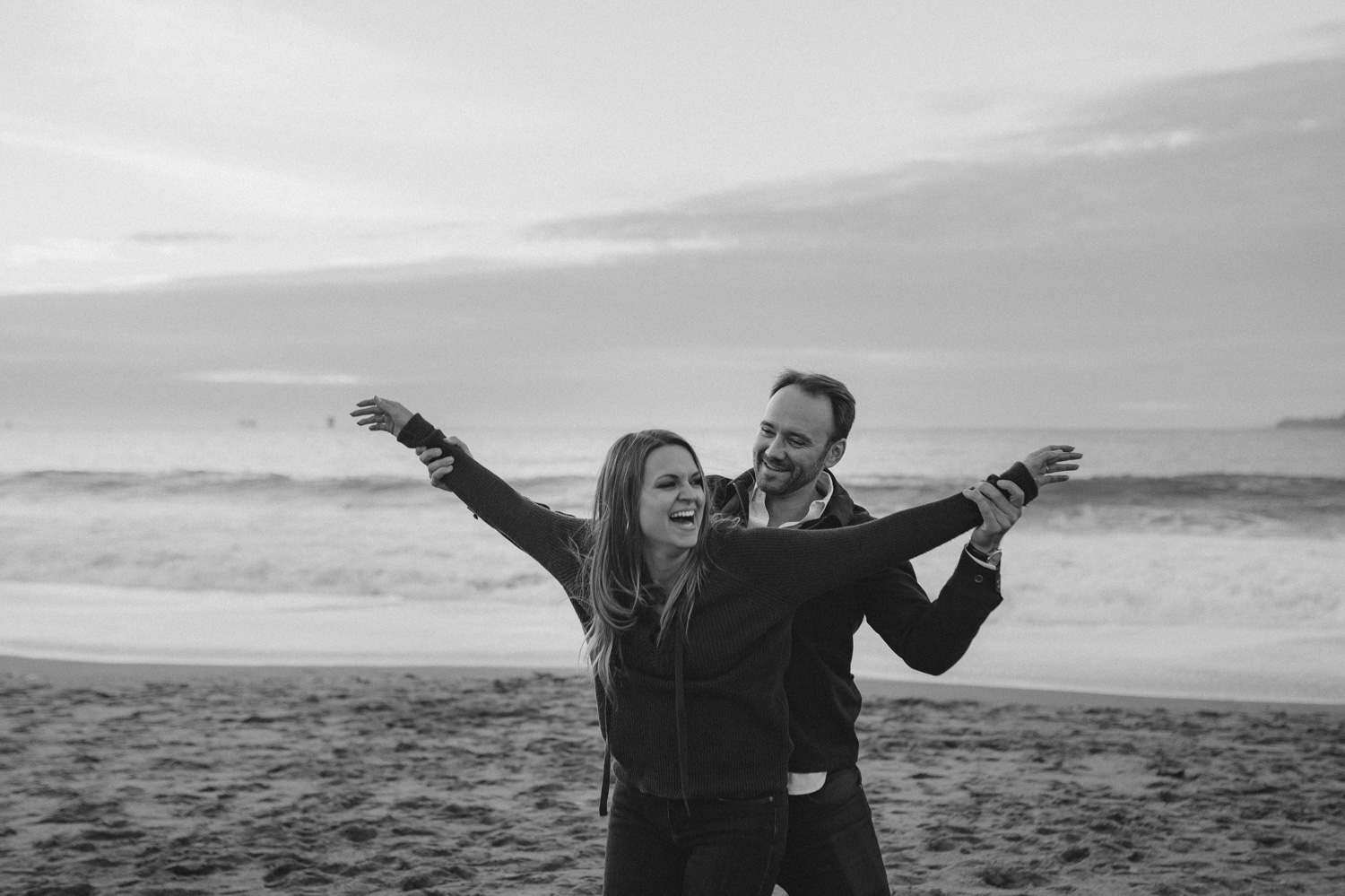 San Francisco engagement couple being silly at Baker Beach photo