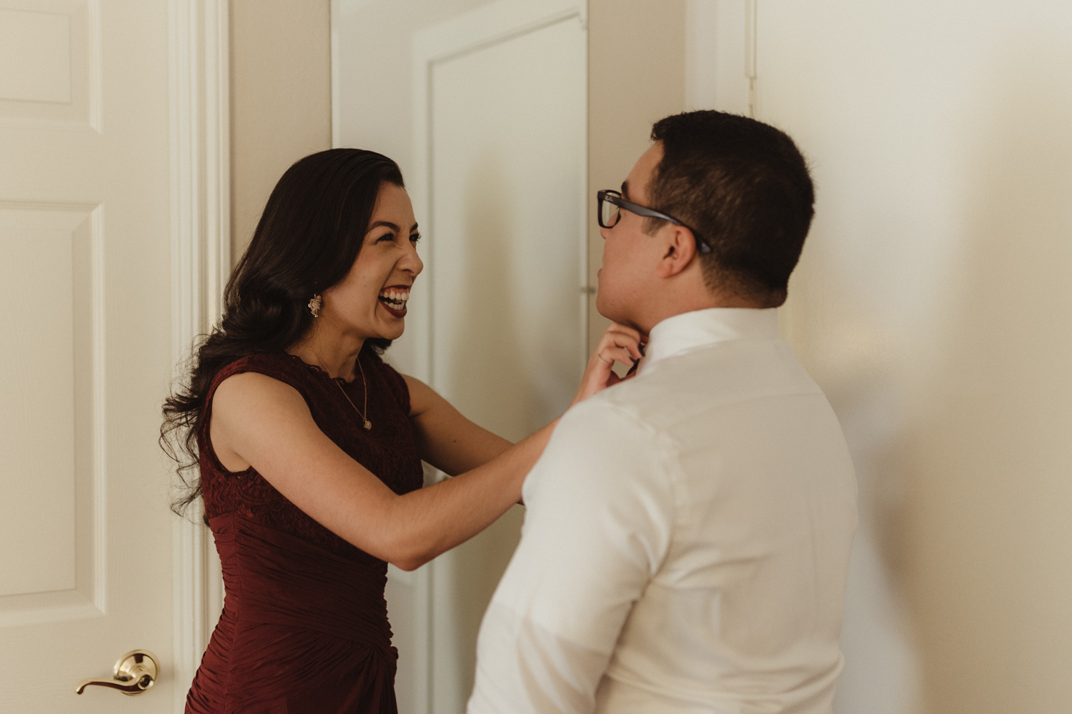 Logan Shoals elopement sister of the groom helping him get ready photo