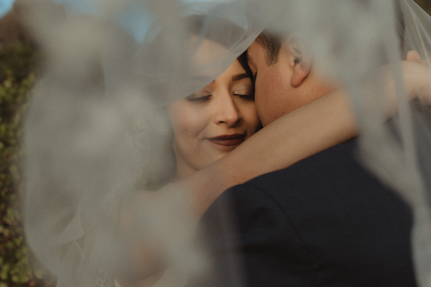 Logan Shoals elopement couple hugging under the veil photo
