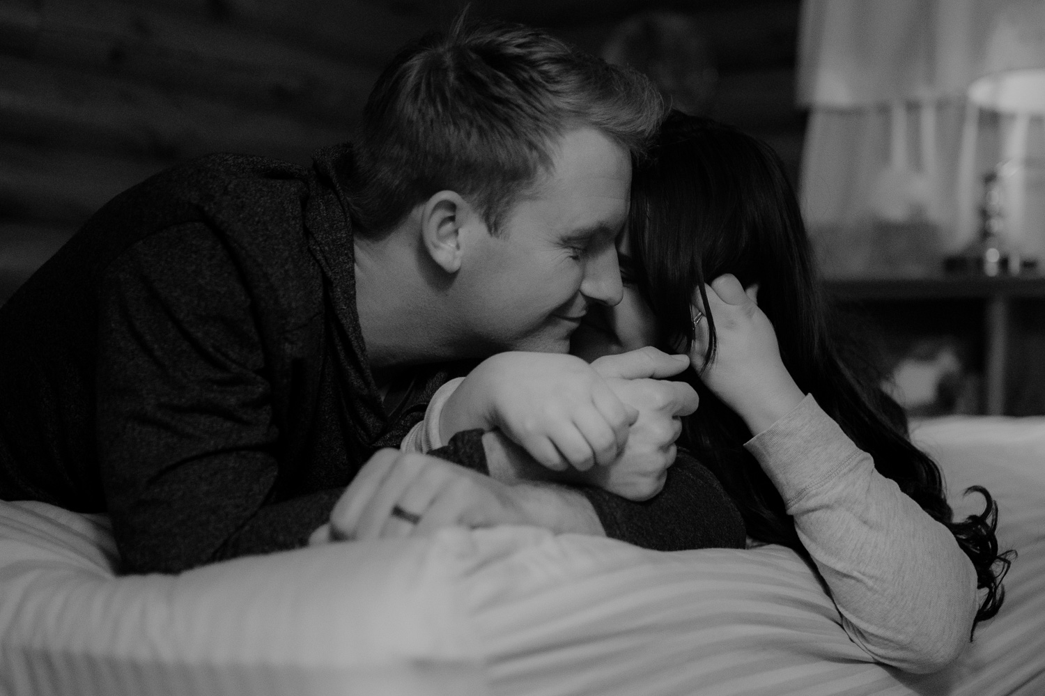 Lake Tahoe cabin engagement inspiration couple cuddling on the bed