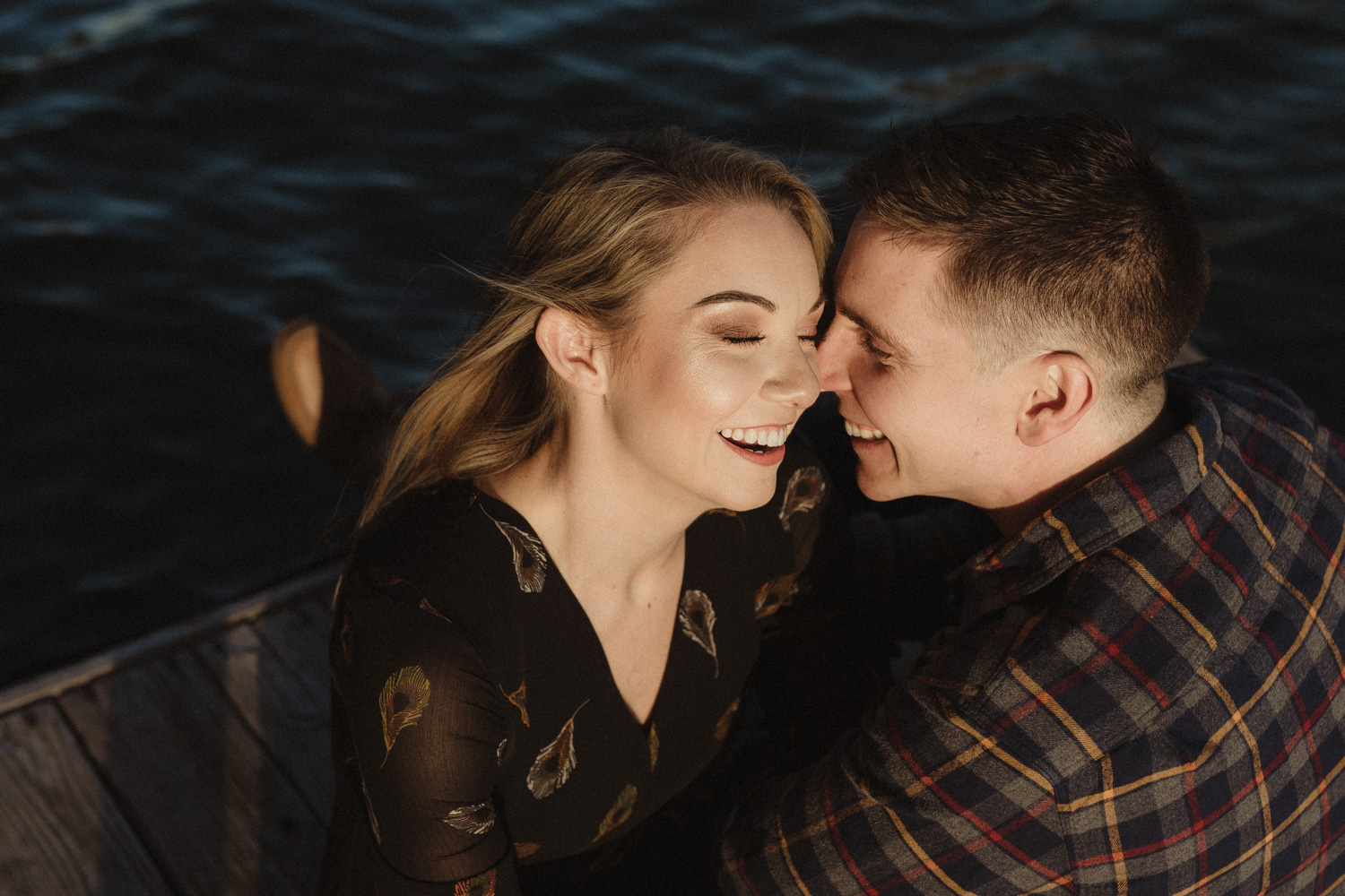 lake tahoe engagement photographer couple sitting on a dock in Truckee, CA photo