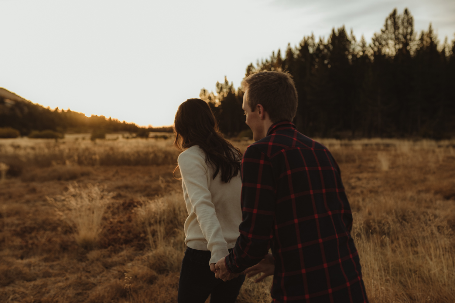 Tahoe meadows interpretive loop romantic sunrise session couple walking into the golden light photo