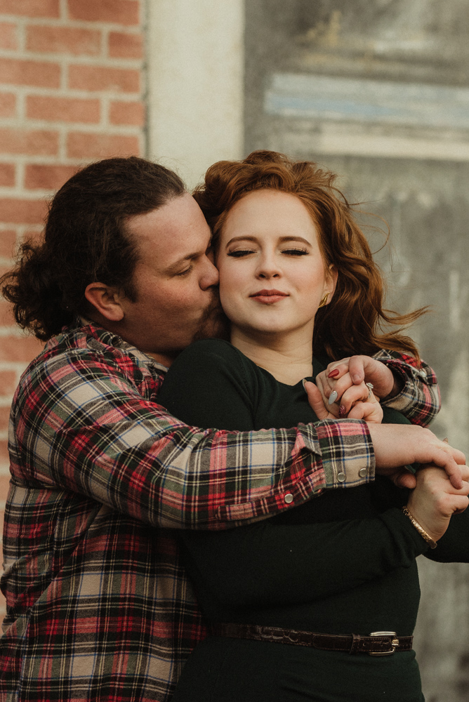 Virginia City Engagement session, couple hugging in front of a mural 