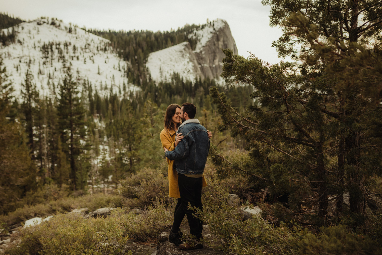 Strawberry California engagement session, couple hugging with lovers leap in the background