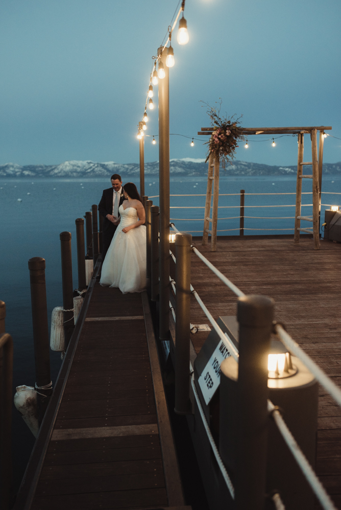 West Shore Cafe Wedding, couple walking on a narrow dock in lake tahoe photo