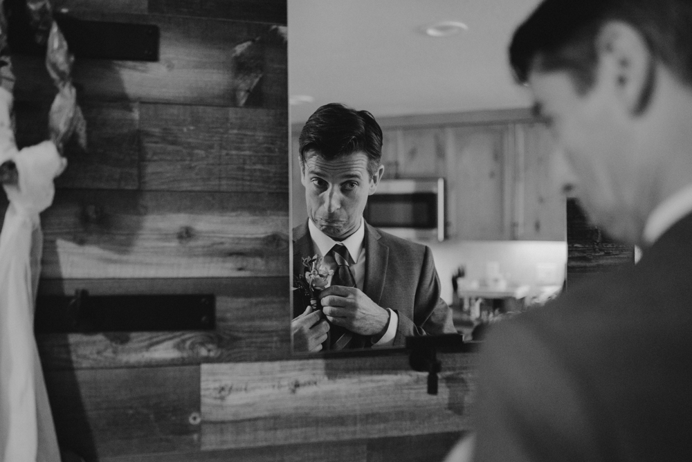 Emerald Bay Elopement, groom putting on his boutonnière photo 