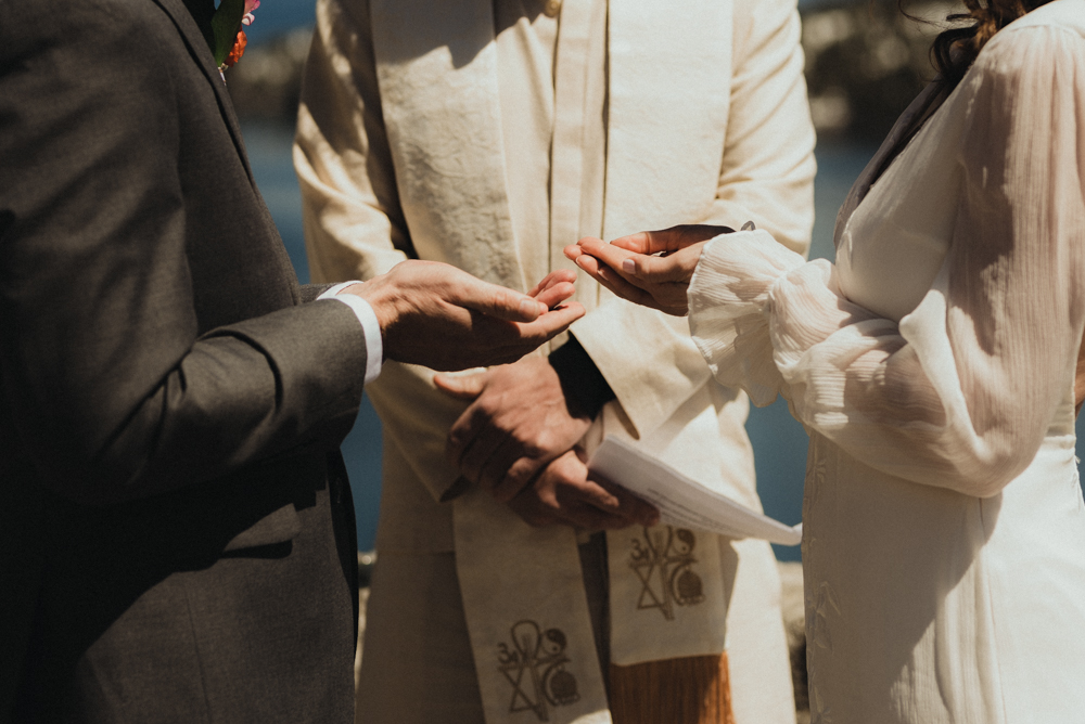 Emerald Bay Elopement, bride and groom holding rings photo