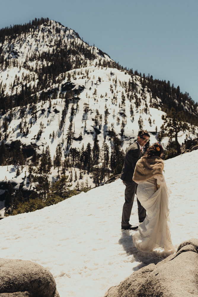 Emerald Bay Elopement couple walking in the snow in april photo