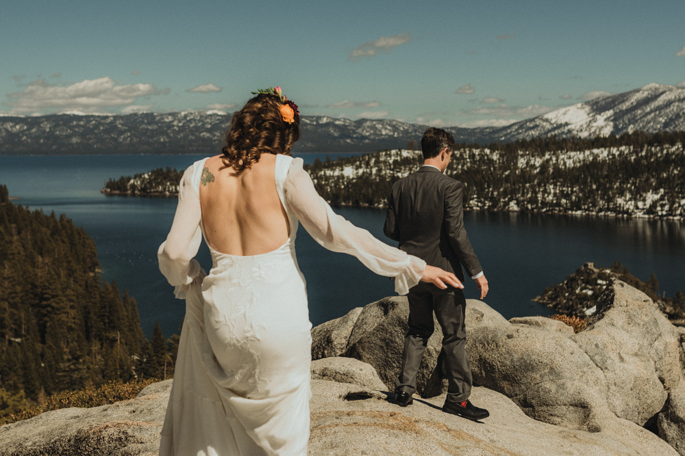 Emerald Bay Elopement in April, couple walking on the rock photo