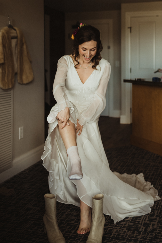 bride putting on her boots photo