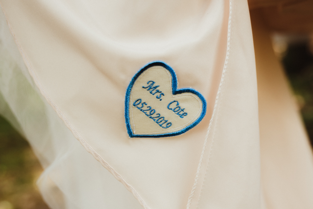 Twenty Mile House Wedding, photo of detail on wedding dress with couples last name and wedding date