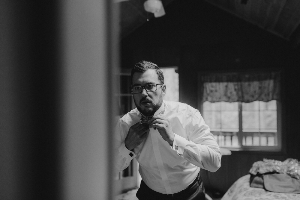 Twenty Mile House Wedding, photo of groom tying his bowtie 