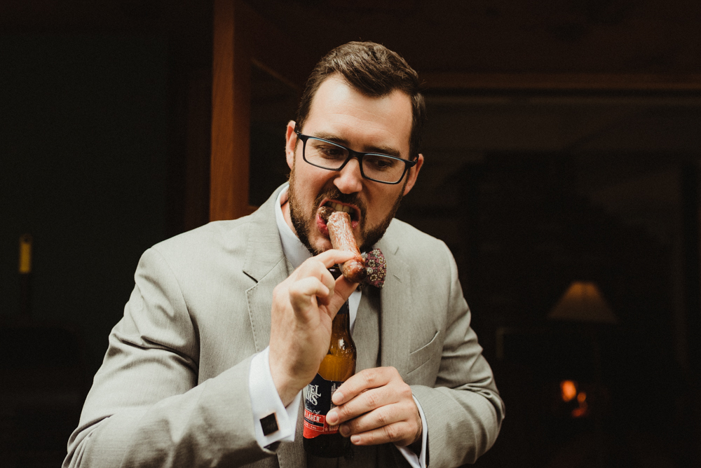 Twenty Mile House Wedding, photo of groom eating a hotdog