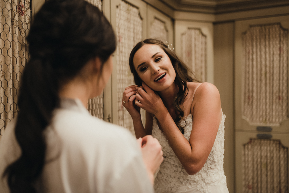 Martis Camp Wedding, bride putting on her earrings photo