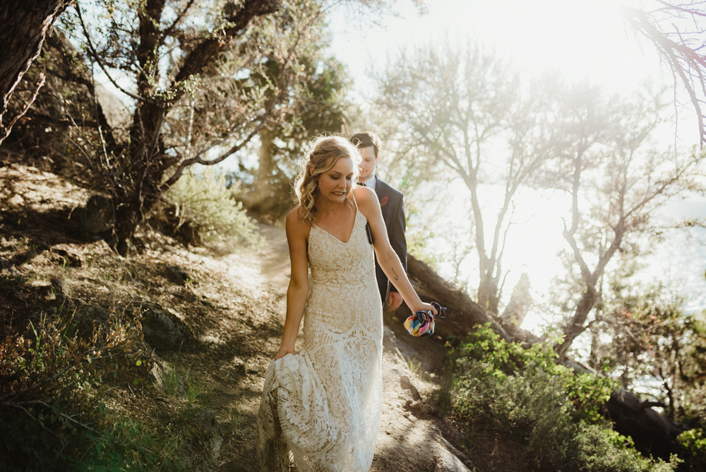 Lake Tahoe Elopement, photo of couple walking on a trail with dust and sun