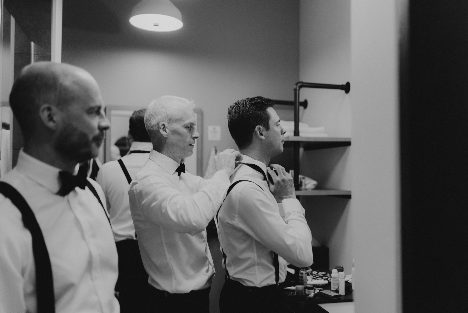 Rush Creek Lodge Wedding, photo of brother helping groom with bowtie 