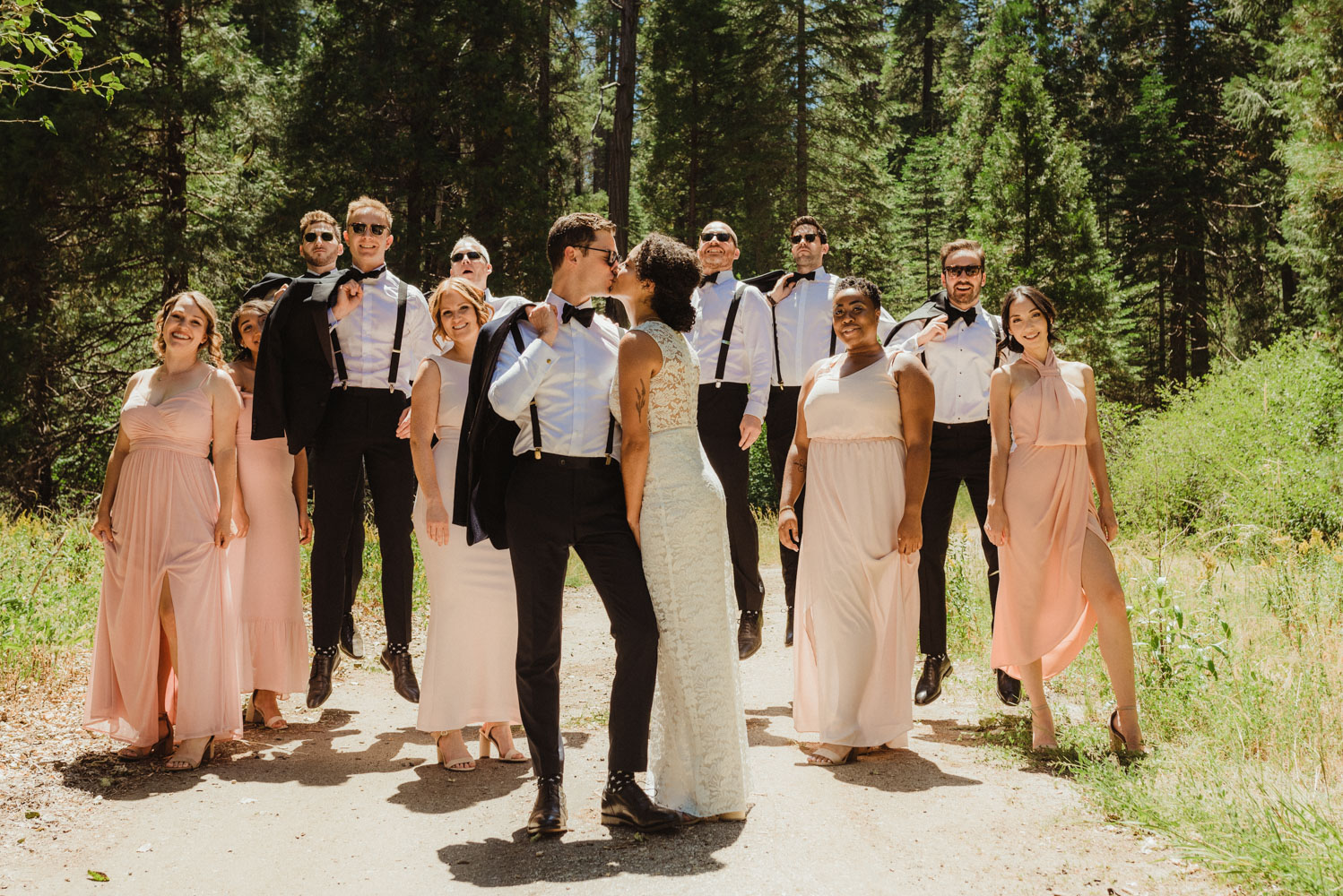 Rush Creek Lodge Wedding, photo of couple kissing with their bridal party behind them