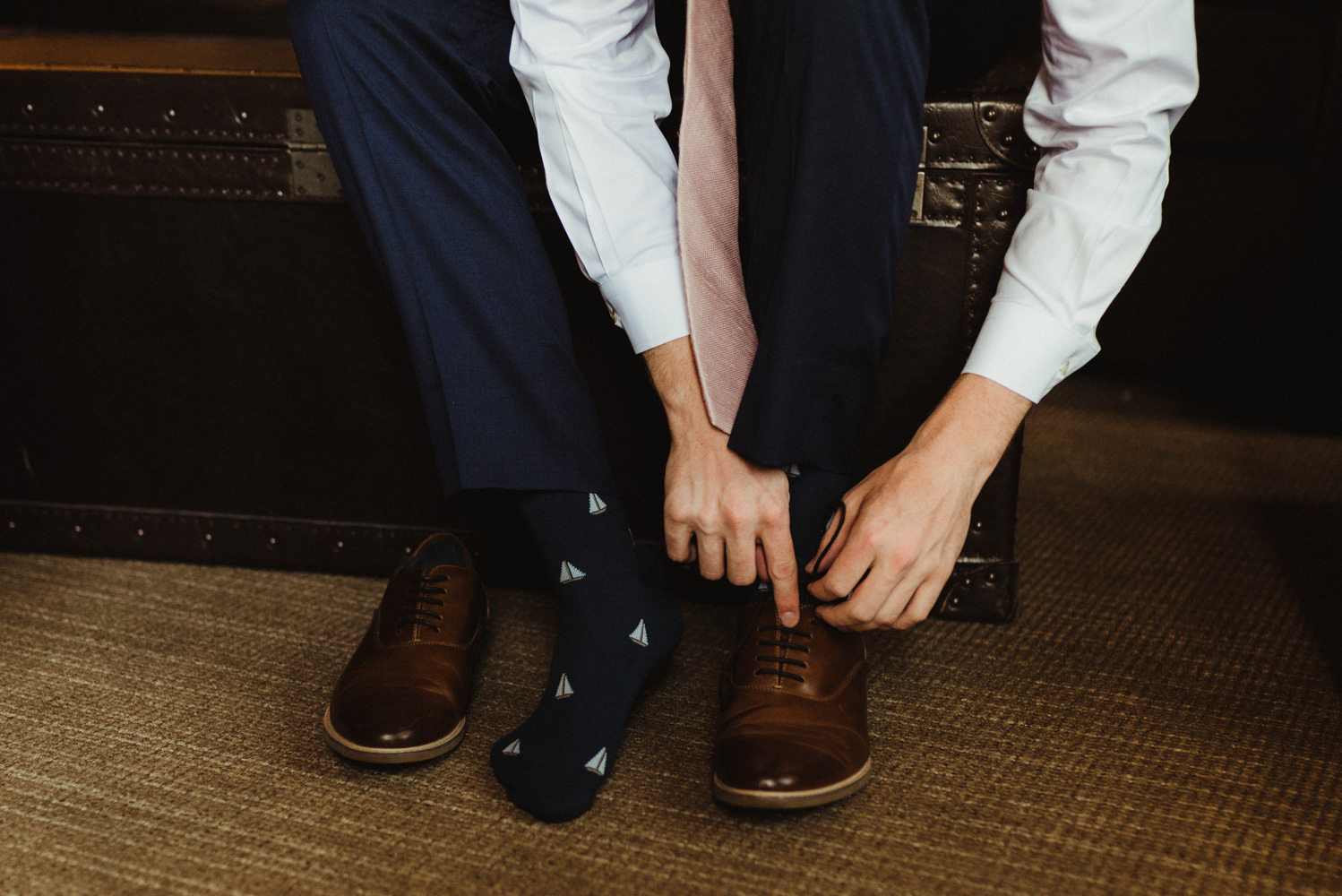 Hellman-Erman Mansion Wedding, photo of groom tying his shoes