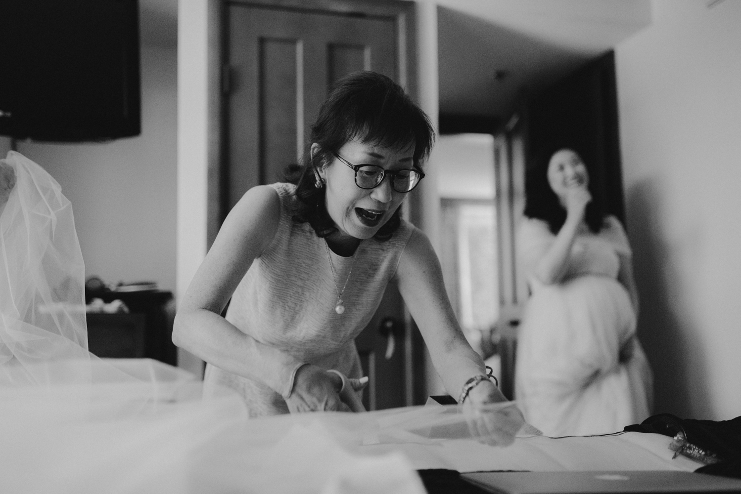 Hellman-Erman Mansion Wedding, photo of mom cutting the veil the day of the wedding