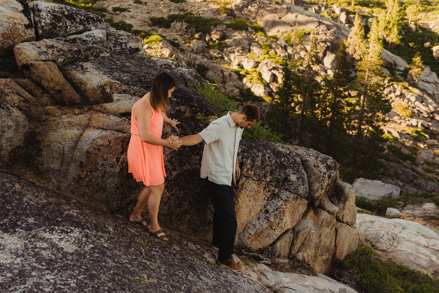 Lake Tahoe Wedding Photographer, photo of couple walking on a rock with bride to be wearing heals 