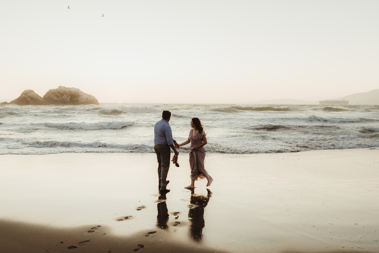 Sutro Baths Engagement Session, couple holding hands by the beach