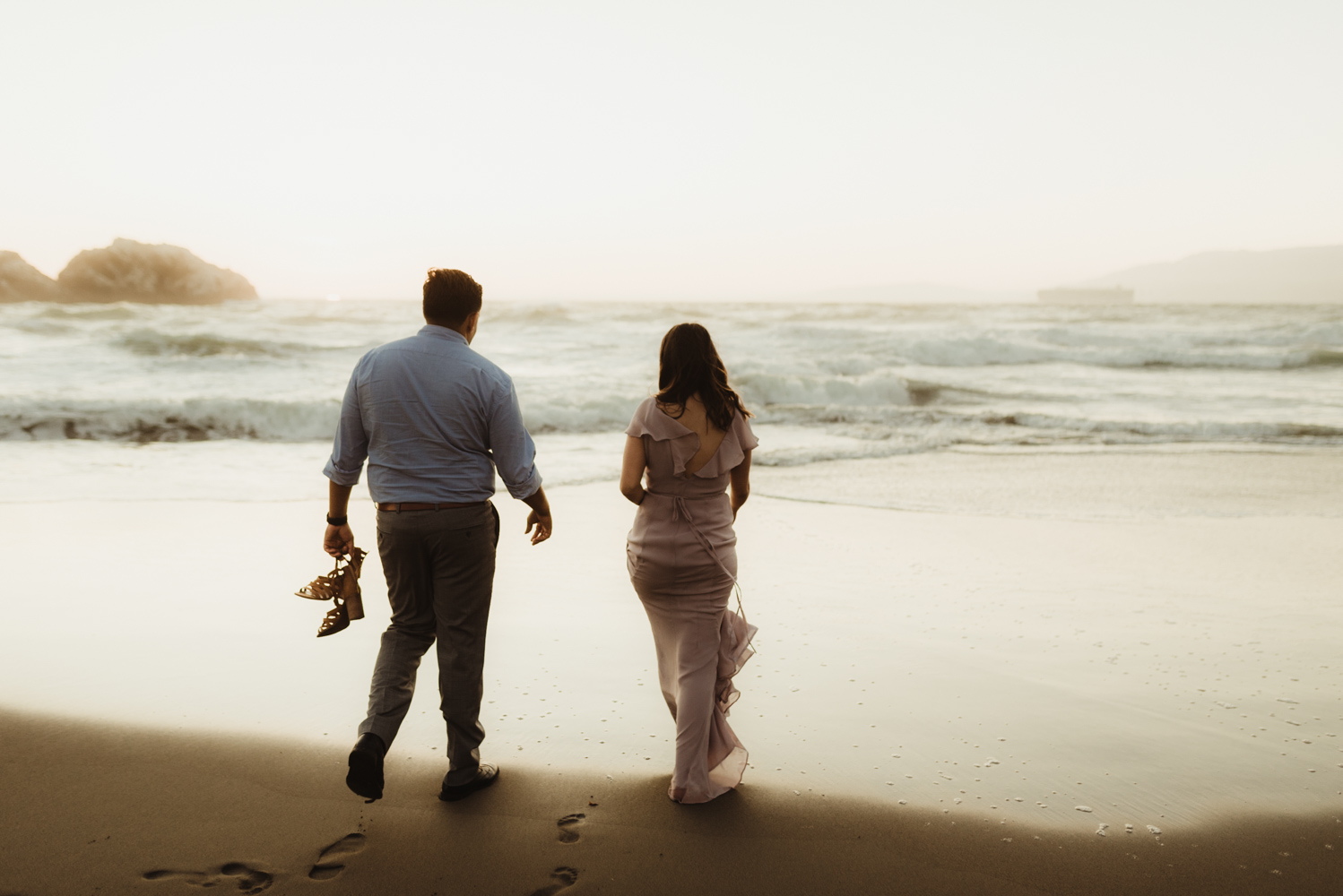 Sutro Baths Engagement Session, photo of couple walking by the ocean