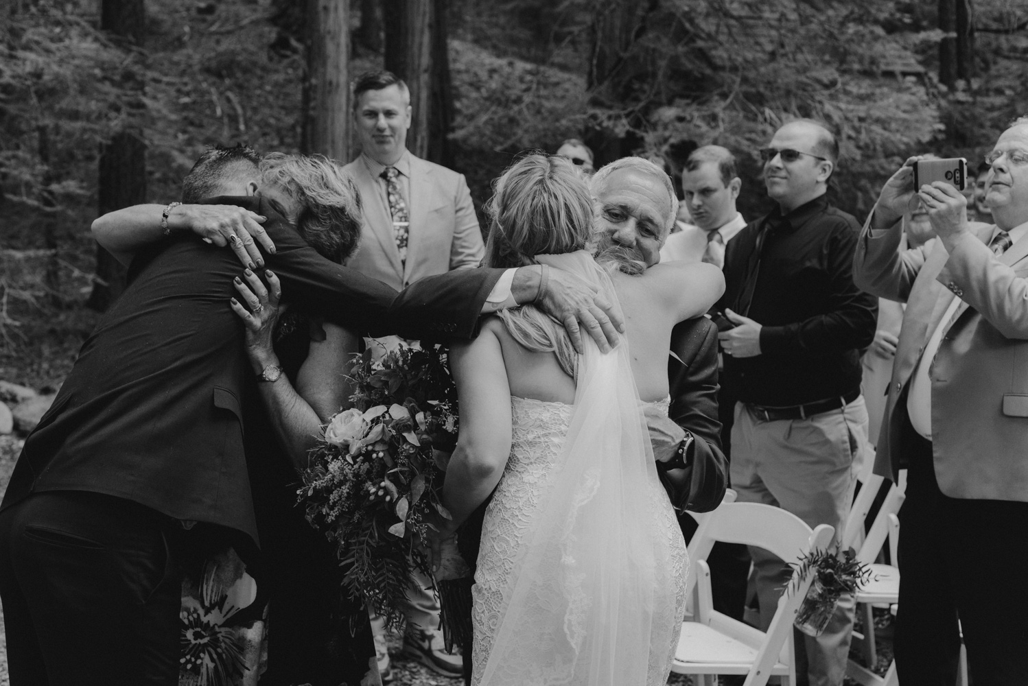 Twenty Mile House Wedding Photographer, bride hugging her dad at the end of aisle 
