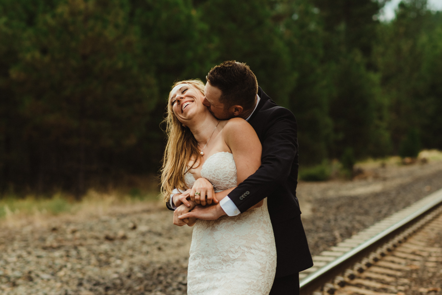 Twenty Mile House Wedding Photographer, photo of couple hugging on the train tracks