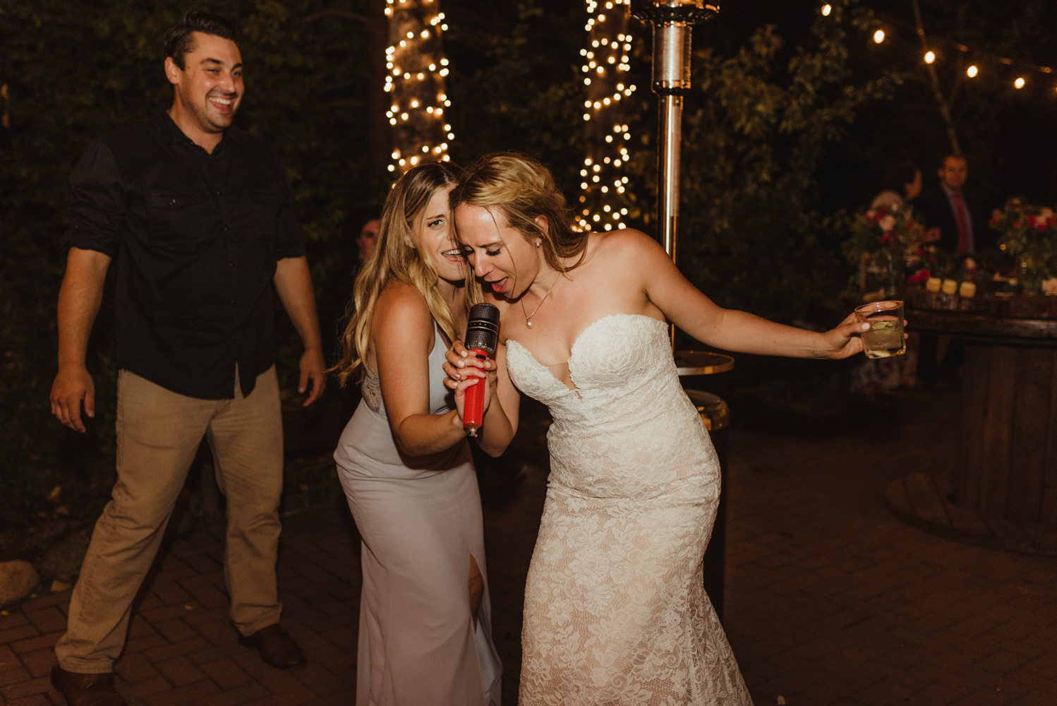Twenty Mile House Wedding Photographer, photo of bride singing into a plastic microphone 