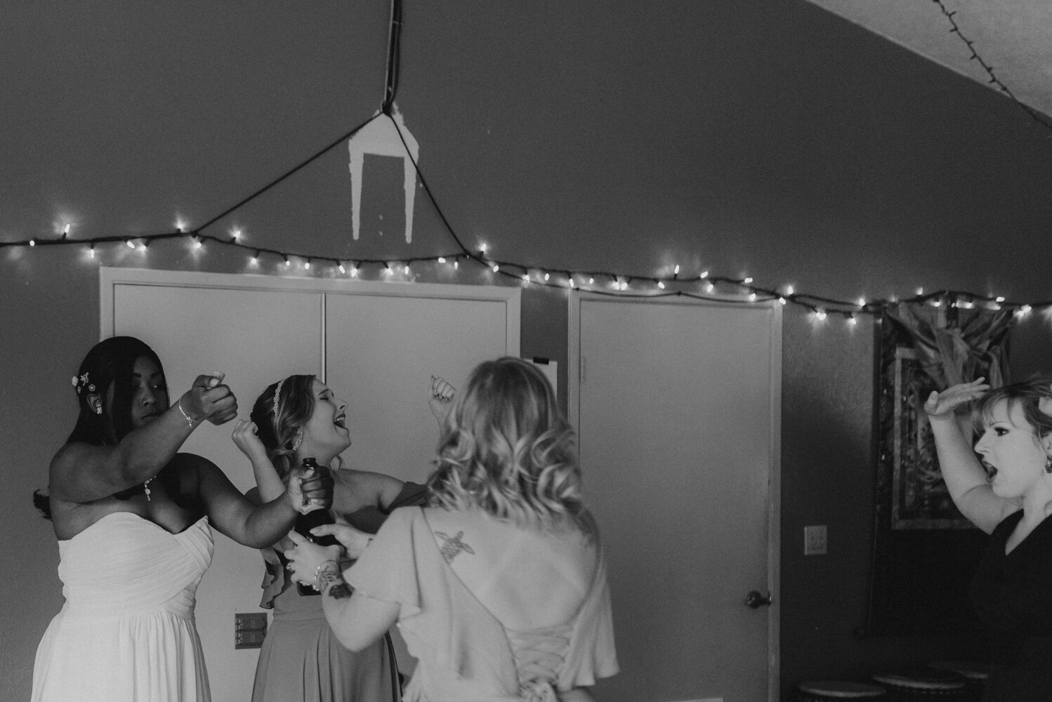 River School Farm Wedding, photo of bridesmaids popping champagne 